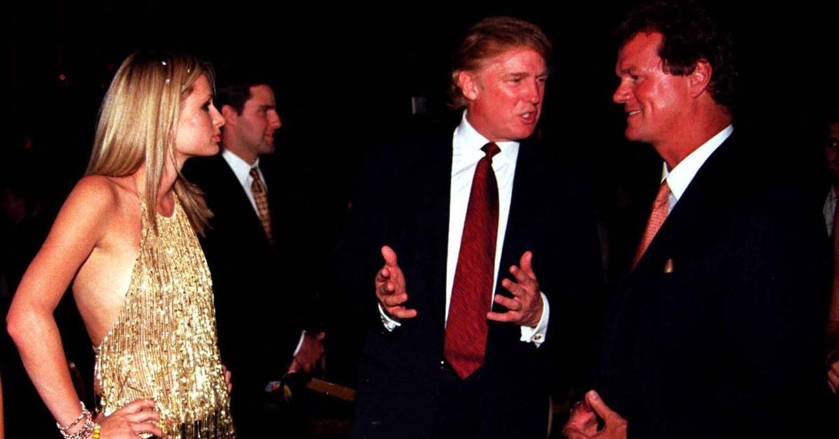 Donald Trump (C) talks to Richard Hilton (R) while Paris Hilton (L) listens