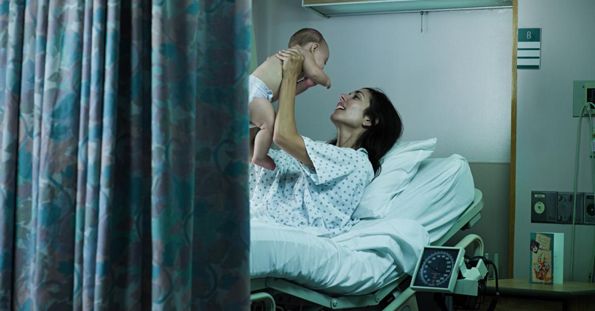 A mother with her newborn baby in the hospital.