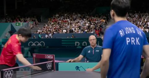 table tennis players touching the table