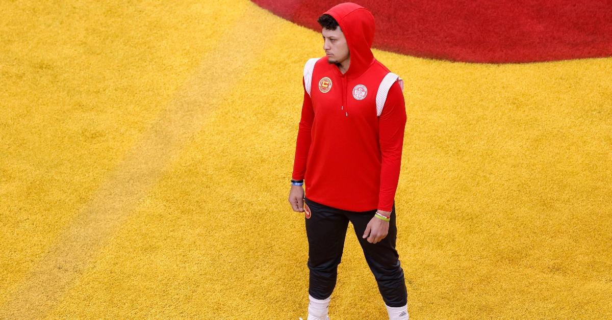 Patrick Mahomes stands on the football field ahead of the 2024 Super Bowl