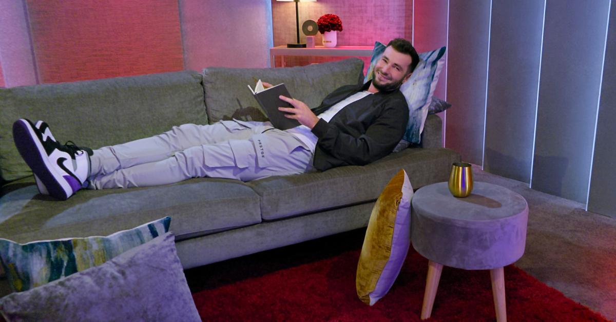 Nick Dorka lays across the couch in the pods during Season 7 of 'Love Is Blind.'