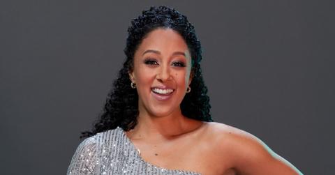 Tamera Mowry-Housley smiles wearing a sparkly dress.