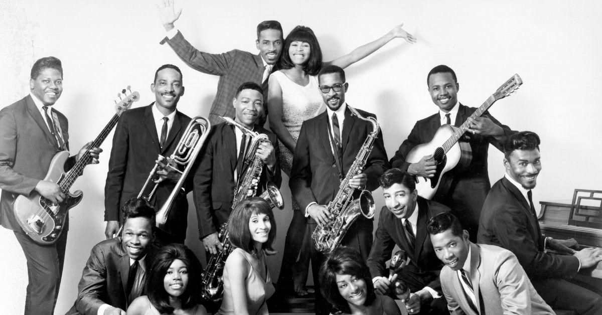 The Ike & Tina Turner Revue posing together in suits and dresses.