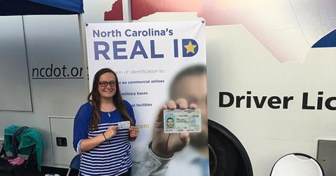 A person holding their Real ID in North Carolina.
