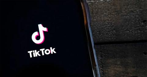 TikTok logo on a black phone screen.