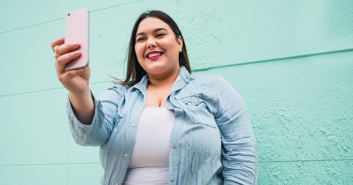 A plus-sized woman taking a photo