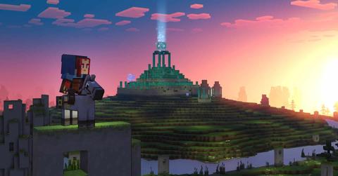 'Minecraft Legends' player on a horse looking at a sunset across a green field.