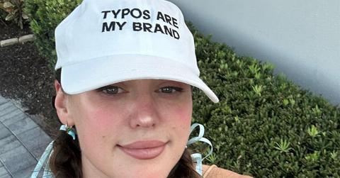 Caroline Calloway with a hat that says "typos are my brand."