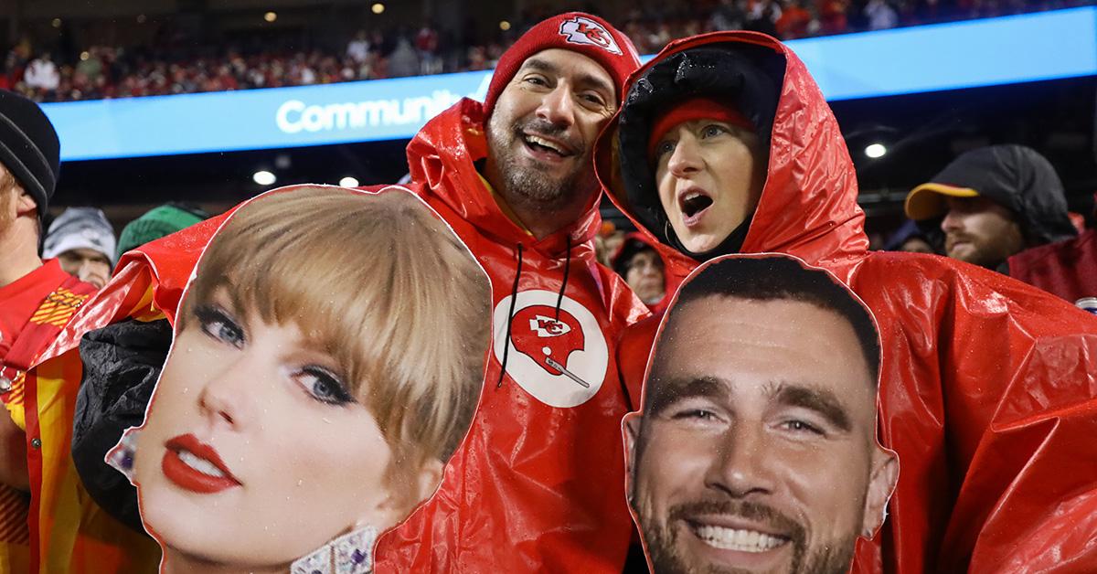 Kansas City Chiefs fans holding cardboard heads of Taylor Swift and Travis Kelce. 