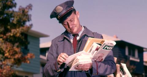 A mailman delivering mail