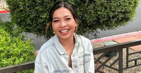 Chau smiling and wearing a denim jacket
