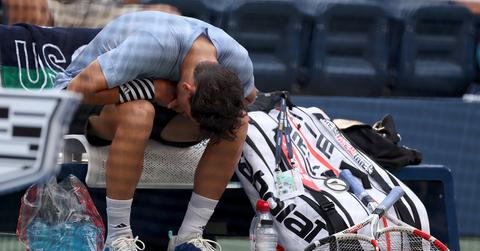 Dominic Thiem leans over on his bench at the US Open.