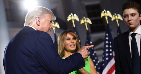 U.S. President Donald Trump (L) gestures, flanked by First Lady Melania Trump and son Barron Trump, on Aug. 27, 2020