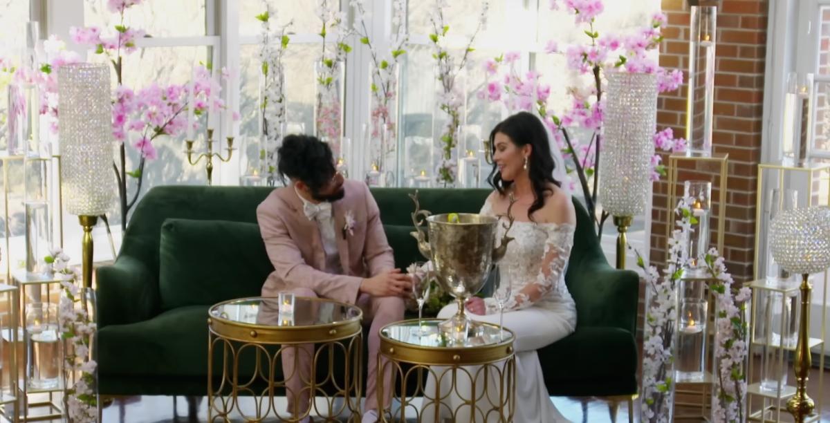 Michael and Chloe sit on a couch on their wedding day on MAFS