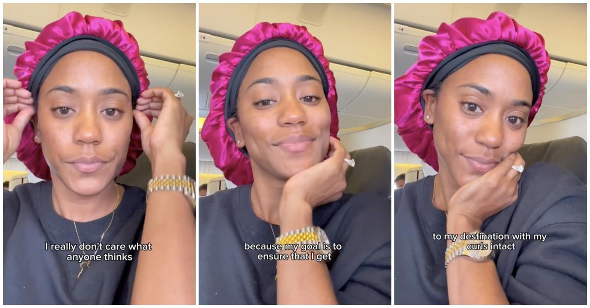 Black woman puts on pink hair bonnet during flight