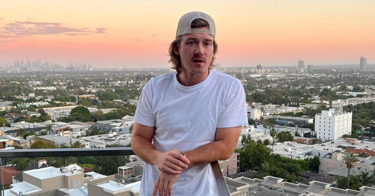 Morgan Wallen stands on a balcony overlooking the city of Los Angeles