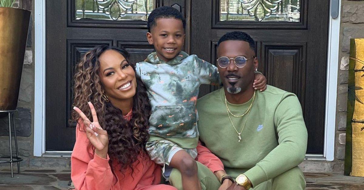 (l-r): Sanya Richards-Ross holding up a peace sign with her son, Deuce, and husband Aaron Ross.