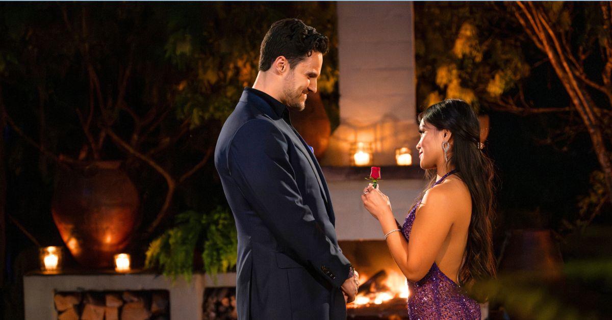 Spencer Conlet smiles has Jenn Tran holds up a rose to give him on 'The Bachelorette'