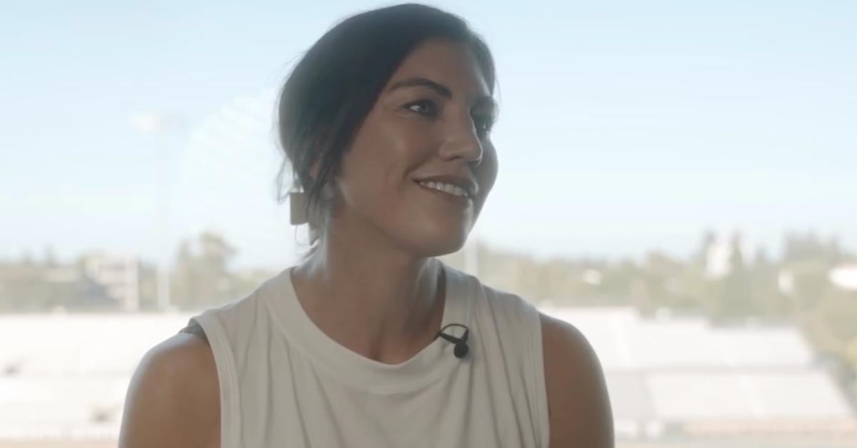 Hope Solo in white tank top, talking in a Homeless World Cup video