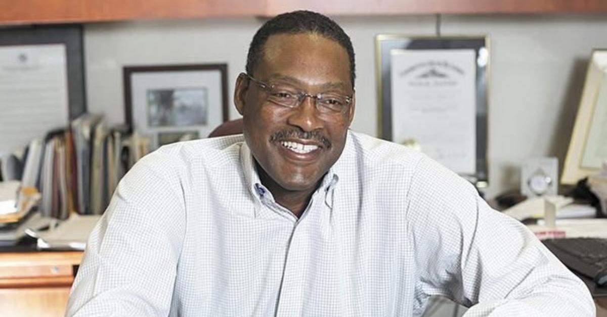 Junior Bridgeman smiling at his desk.