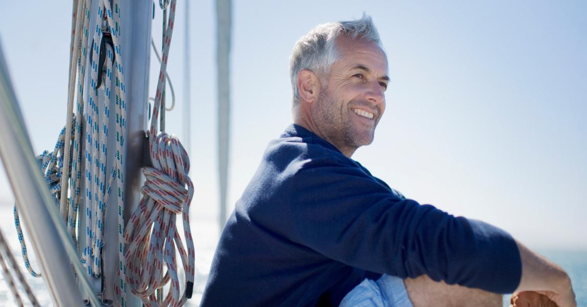 A man sitting on the deck of a boat.