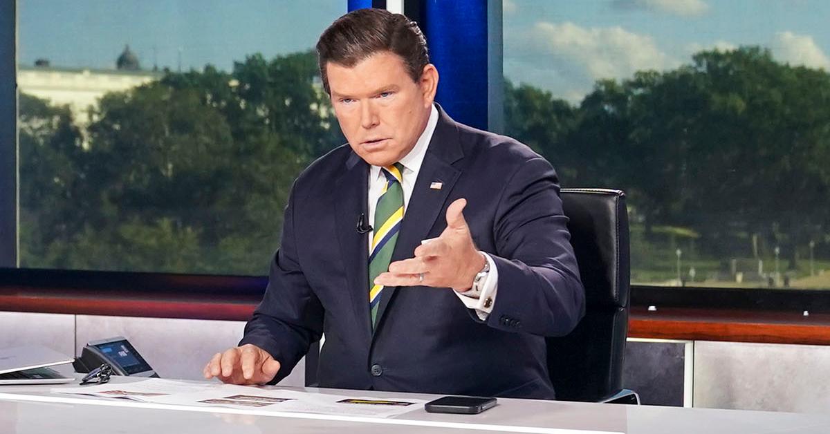 Brett Baier sitting behind a newsdesk