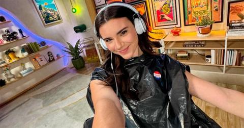 Brett Cooper in her podcast studio with headphones on.