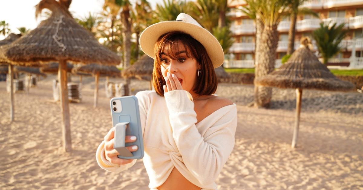 woman taking selfie of herself at a beach 