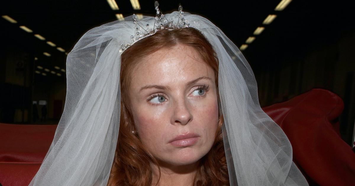 An angry bride wears a veil on her wedding day.