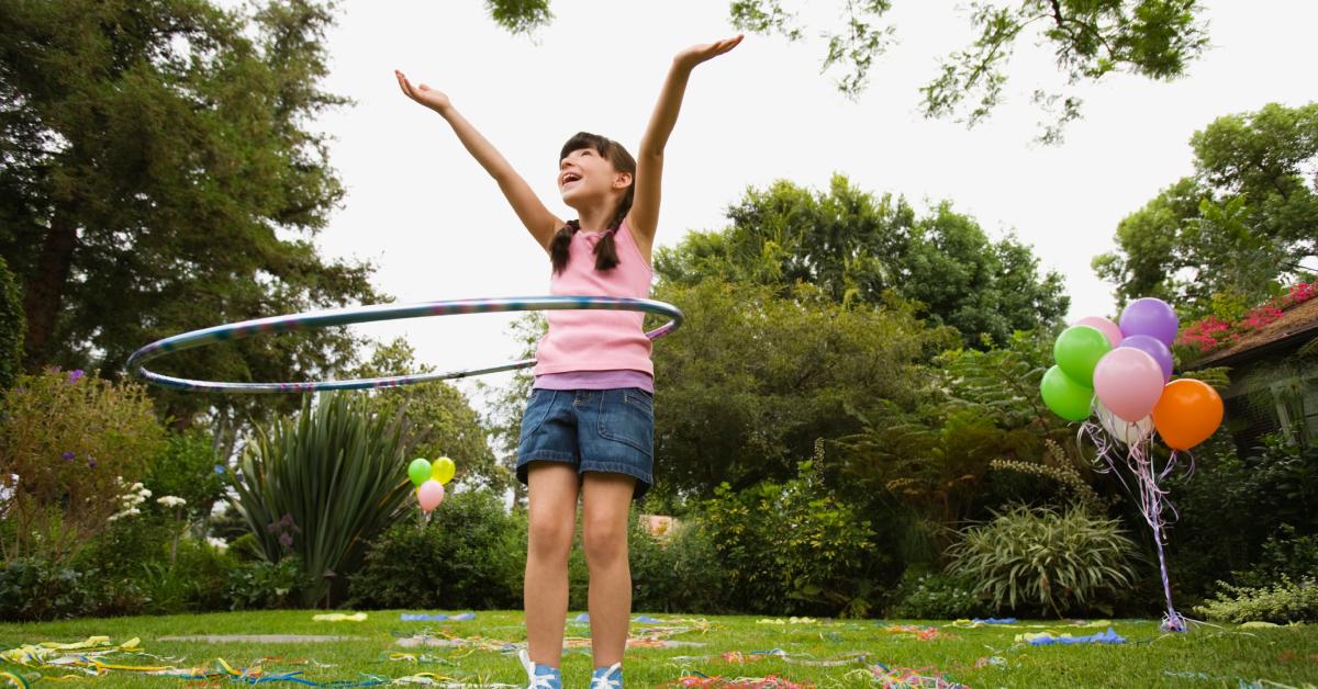 Girl playing with a hula hoop at birthday party