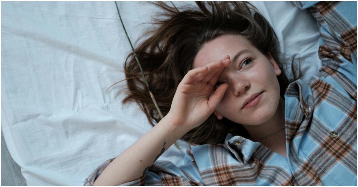 A girl waking up rubbing her face