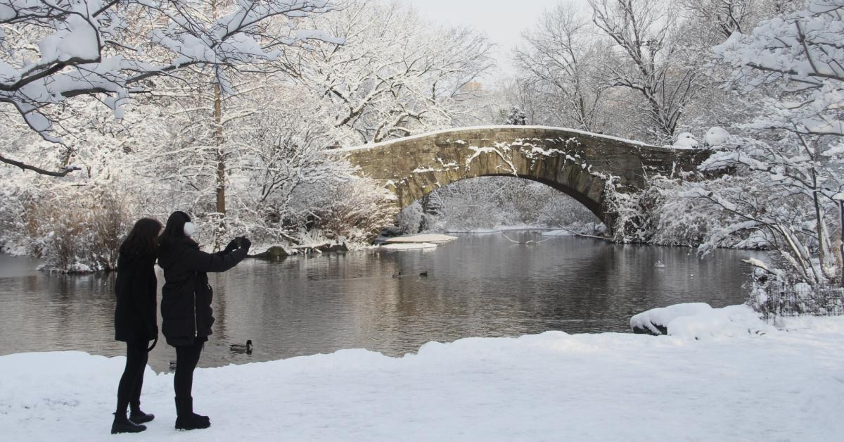 Two people take a photo in the snow in NYC in January 2022.