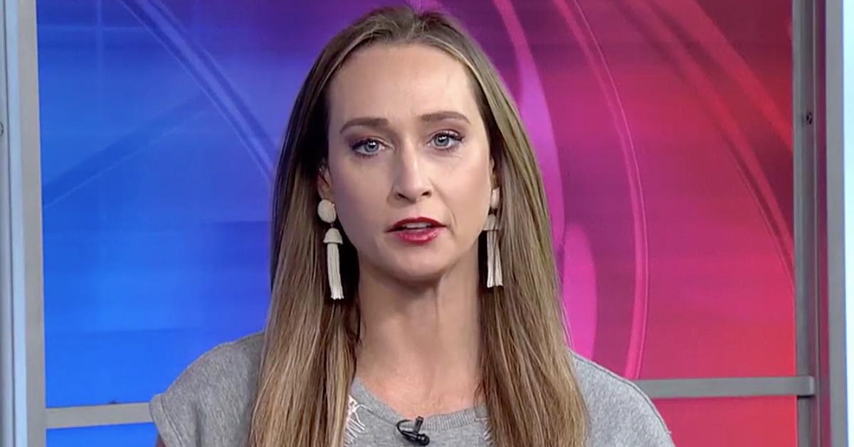 Amanda Hanson wears gray top and dangly earrings on set of K8 News