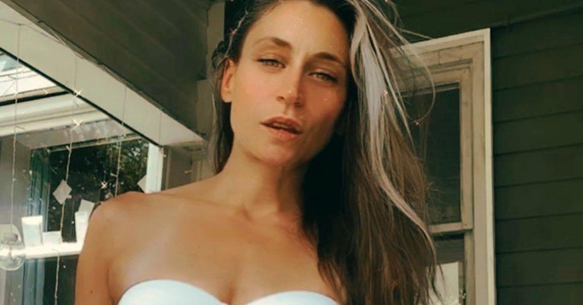 Reina Guarini poses on Instagram wearing a white top