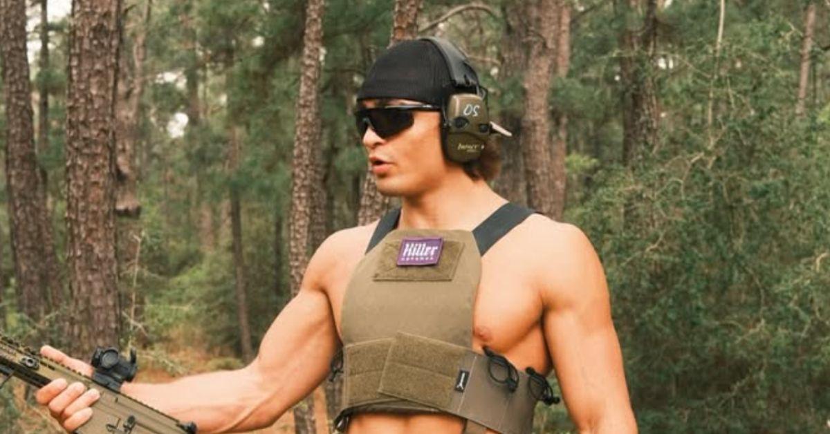 Jay Rod holding a gun without his shirt on. 