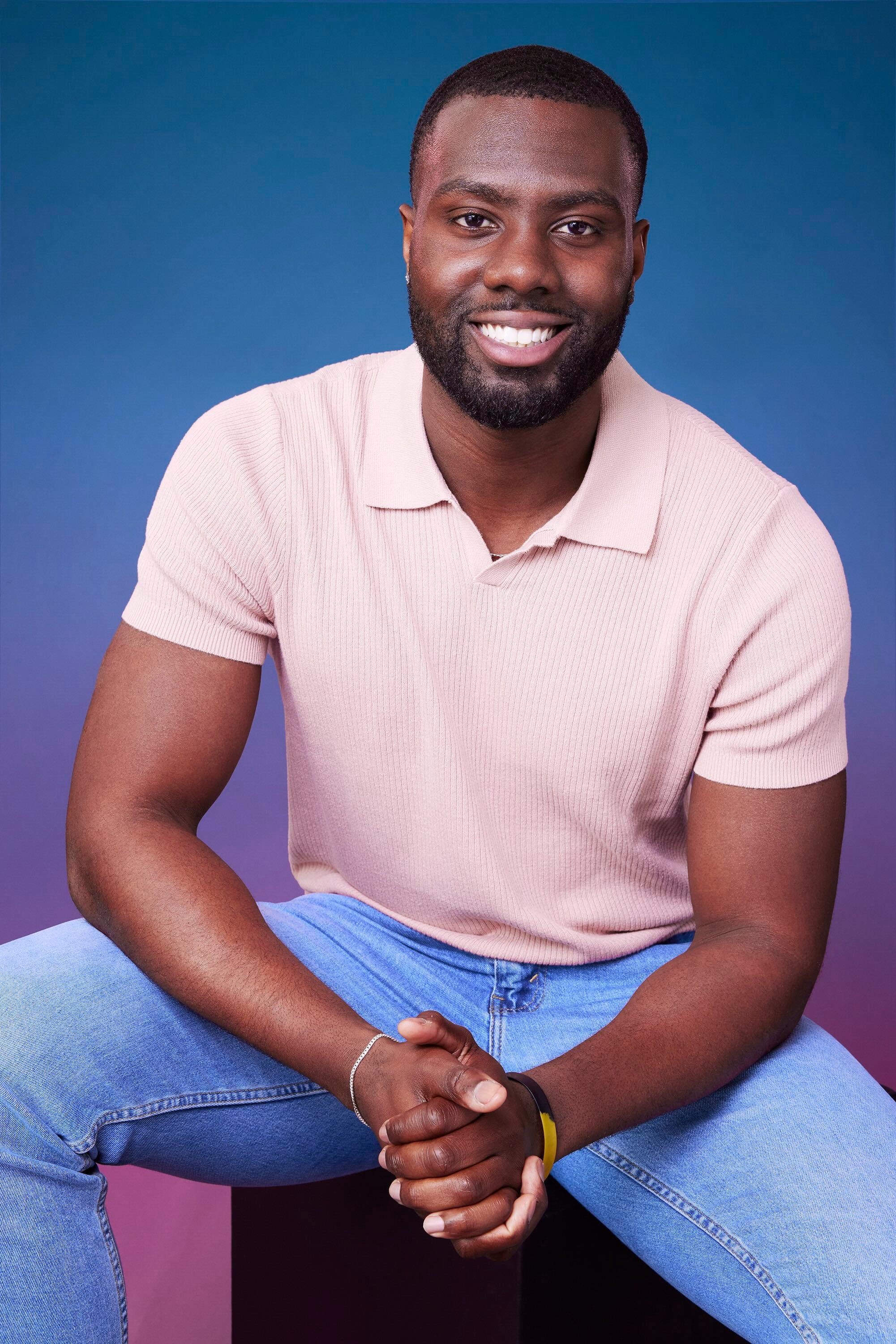 John poses in front of a blue-purple ombré background for his official 'The Bachelorette' Season 21 portrait.