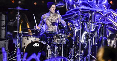 Travis Barker performing on the drums.