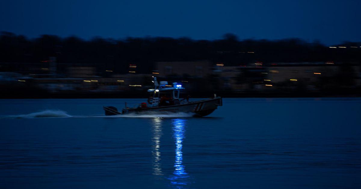 A boat searching the Potomac following the plane crash. 