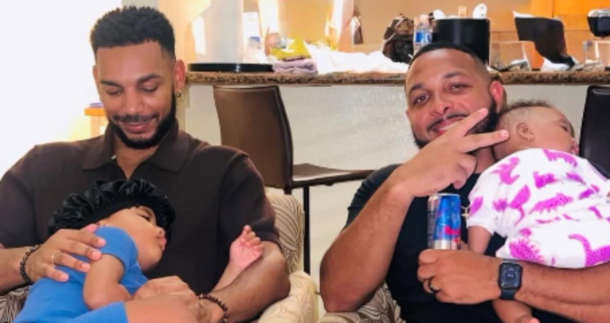 Jamal and Larry sit together on a couch with Jamal's daughter.