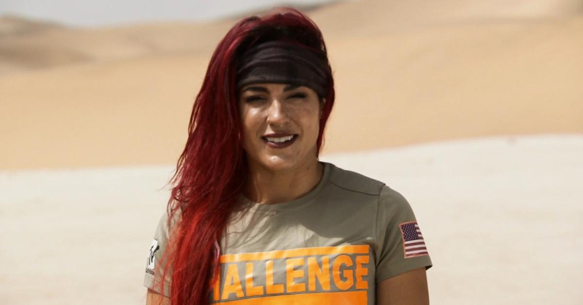 Cara in a desert with a gray headband on The Challenge