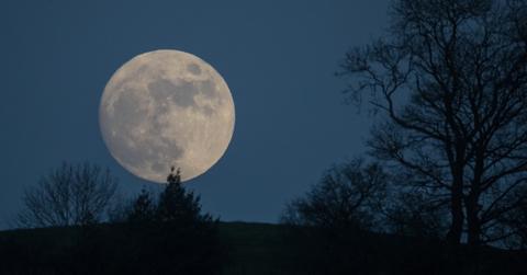 An image of a 'wolf moon' over Glastonbury.