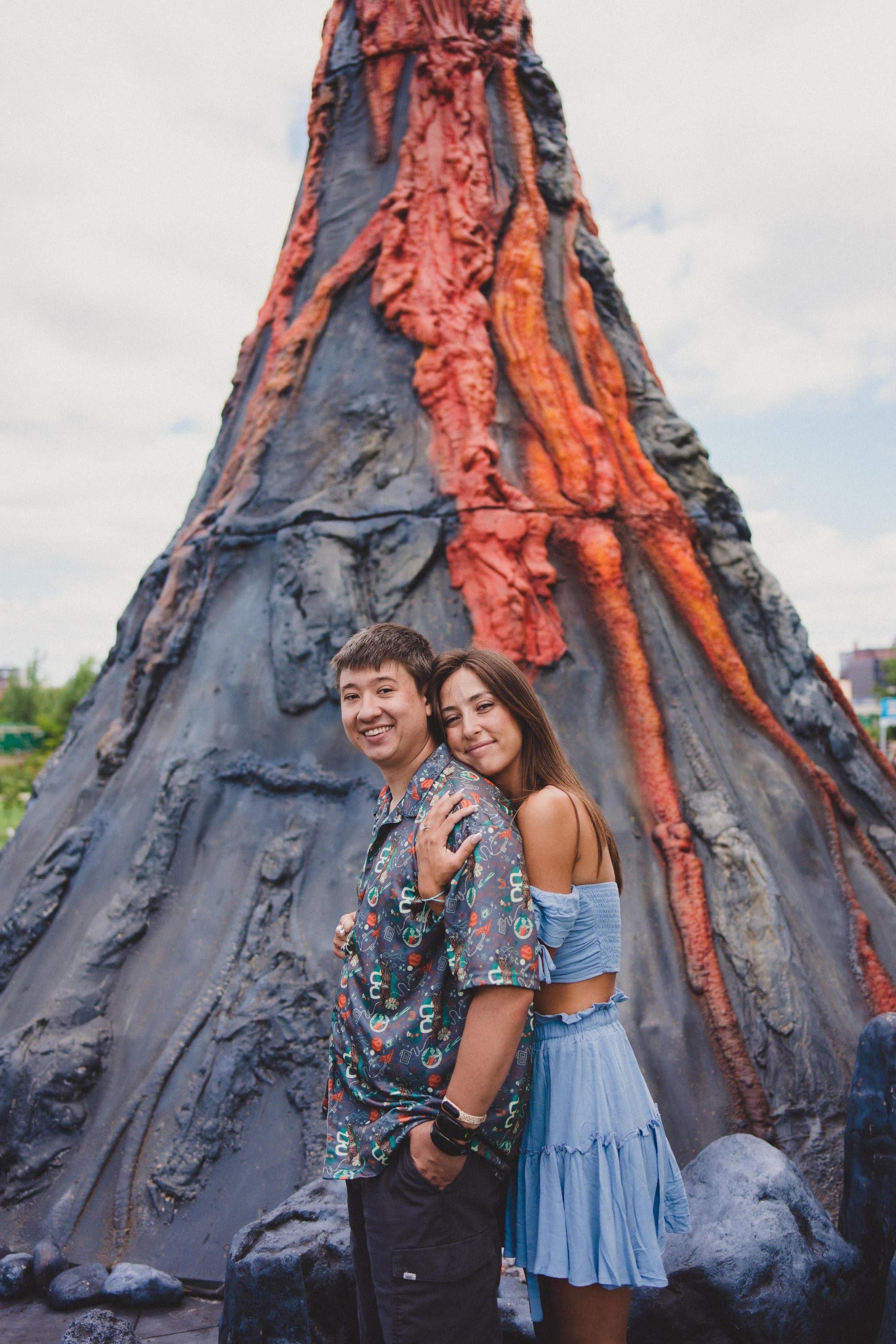 Brad and Kelsi posing in front of the volcano photo op at the NYC GO Fest.