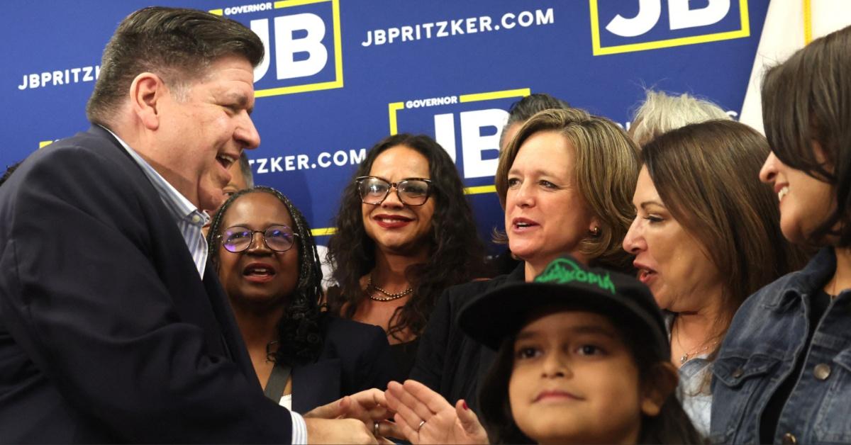 JB Pritzer greets Texas House Democrats before a press conference.