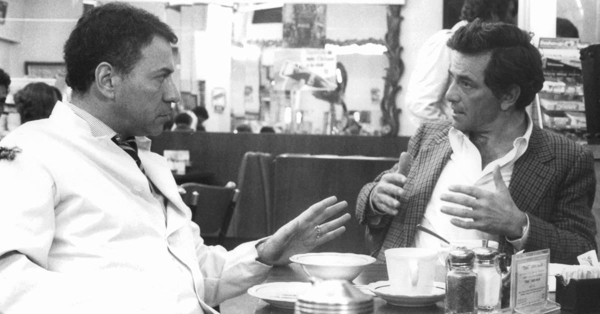 Peter Falk sitting at a diner talking with an Alan Arkin in a scene from the film 'The In-Laws', 1979. 