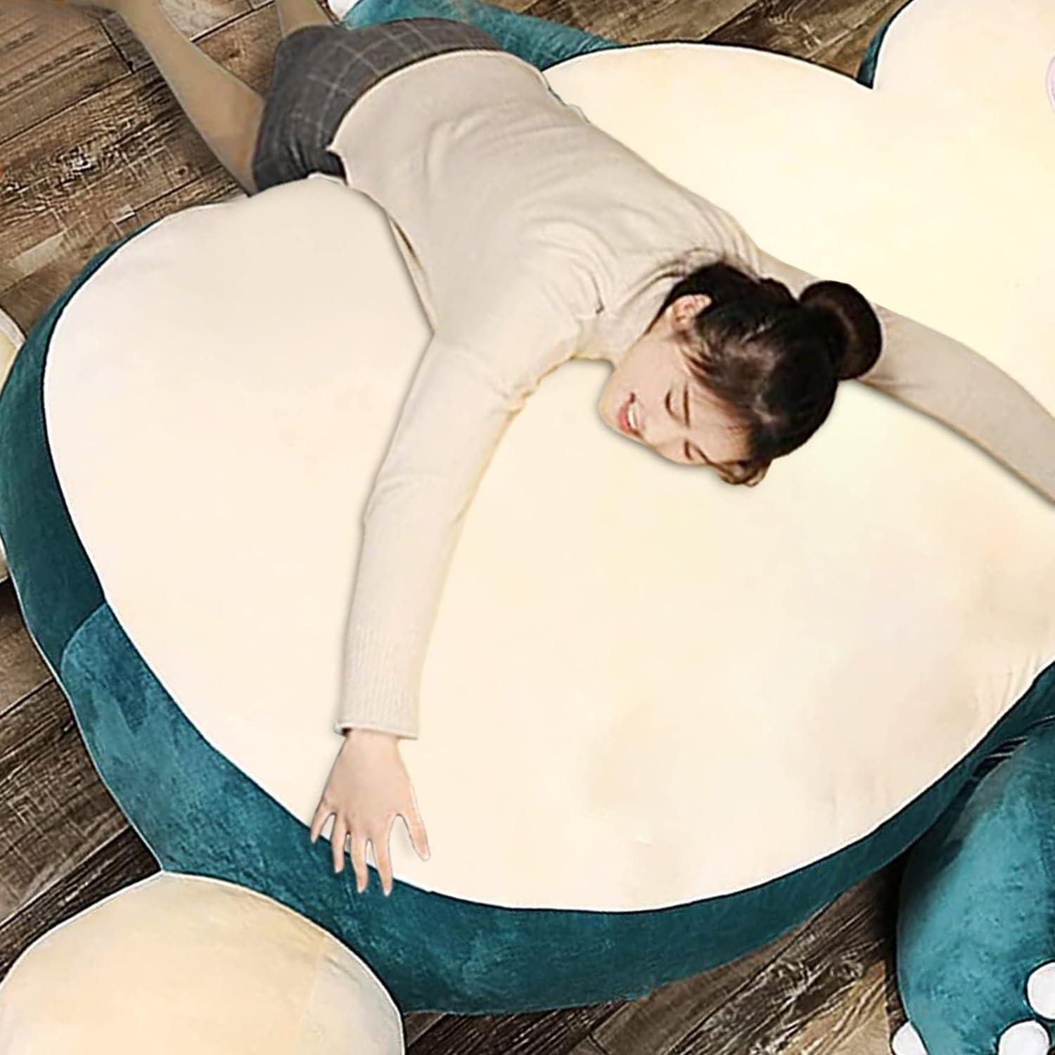 A girl laying on top of a bean bag that looks like snorlax