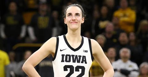 Caitlin Clark smiling as the crowd cheers after she broke the NCAA women's all-time scoring record on Feb. 15, 2024