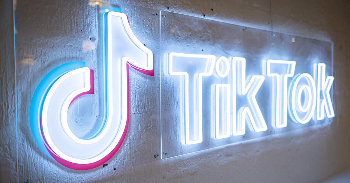 The TikTok logo in neon lights. 