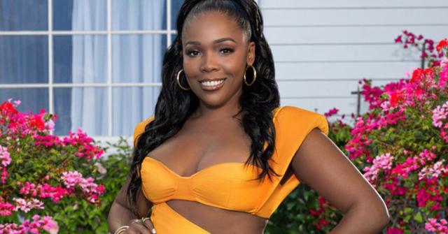 Jasmine Goode in an orange dress