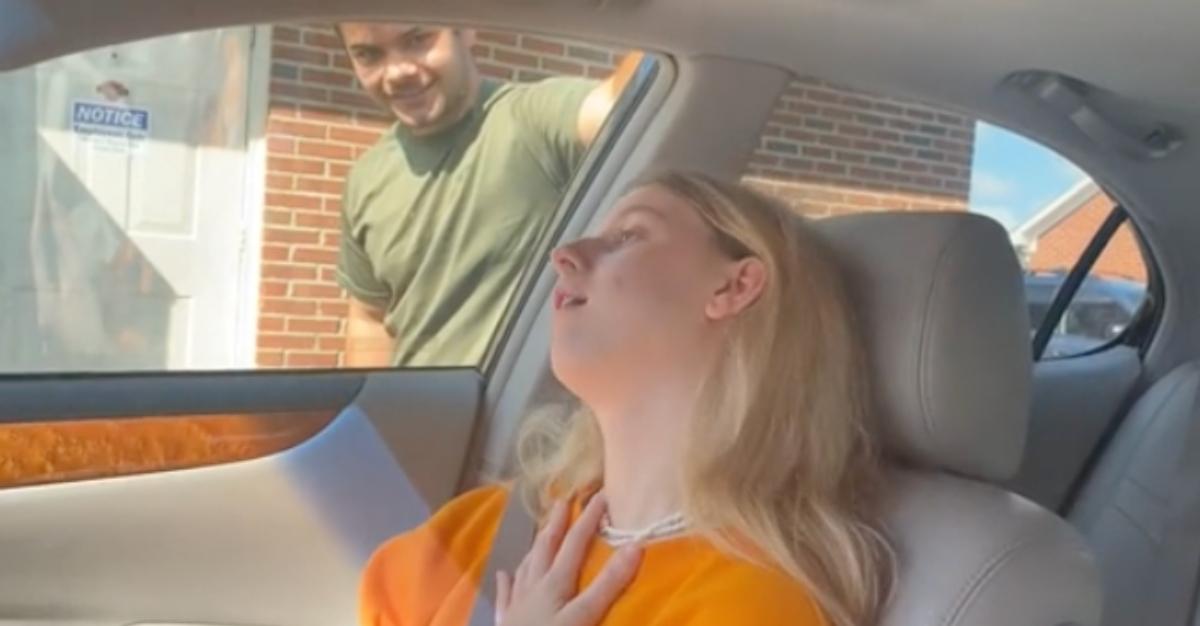 A woman sitting in a car after getting her wisdom teeth removed