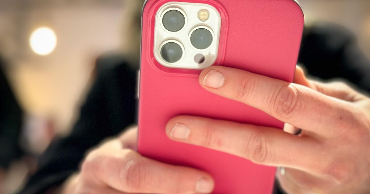 A woman holds an iPhone